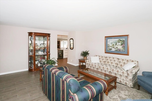 living room featuring beverage cooler, baseboards, and wood finished floors