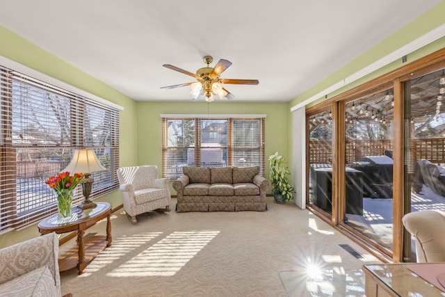 sunroom / solarium with visible vents and a ceiling fan