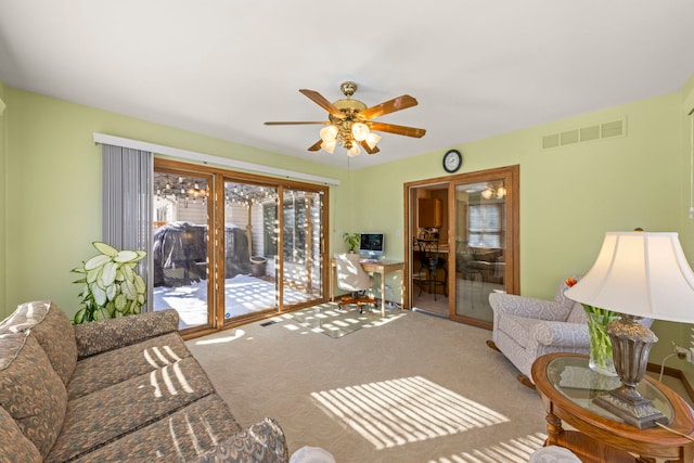 carpeted living room featuring visible vents and ceiling fan