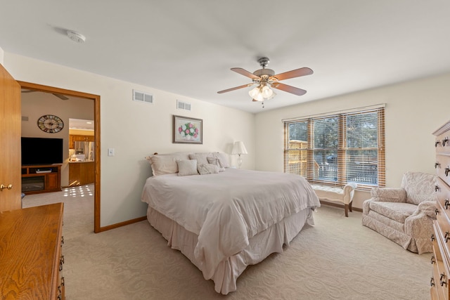 bedroom with light colored carpet, visible vents, ceiling fan, and baseboards