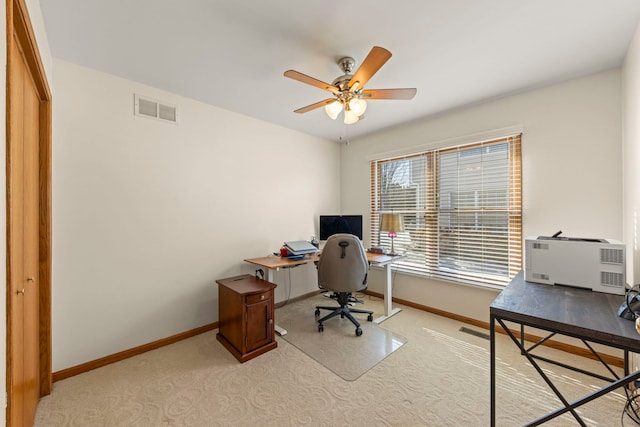 office space with carpet floors, baseboards, visible vents, and ceiling fan