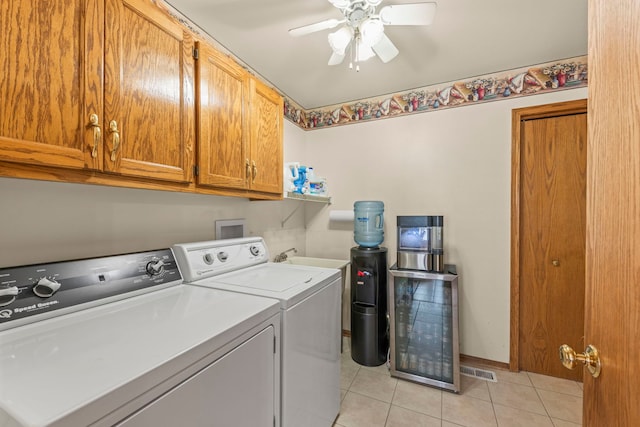 laundry area with light tile patterned floors, cabinet space, ceiling fan, washer and dryer, and baseboards