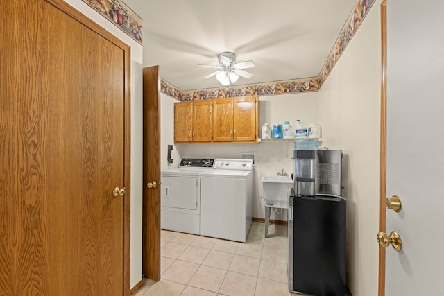 laundry area featuring cabinet space, light tile patterned floors, ceiling fan, separate washer and dryer, and a sink