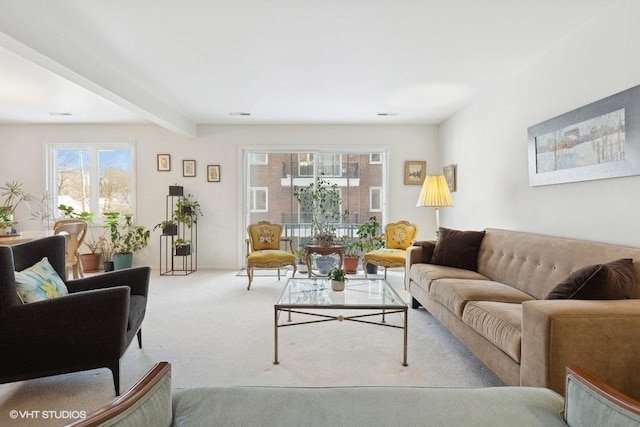 living room featuring light carpet and beam ceiling