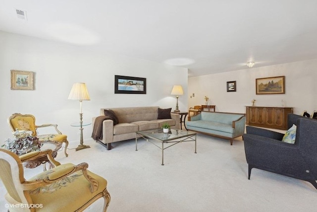 living room featuring visible vents and light colored carpet