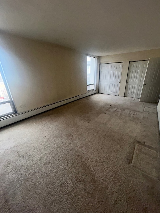 unfurnished bedroom with carpet and two closets