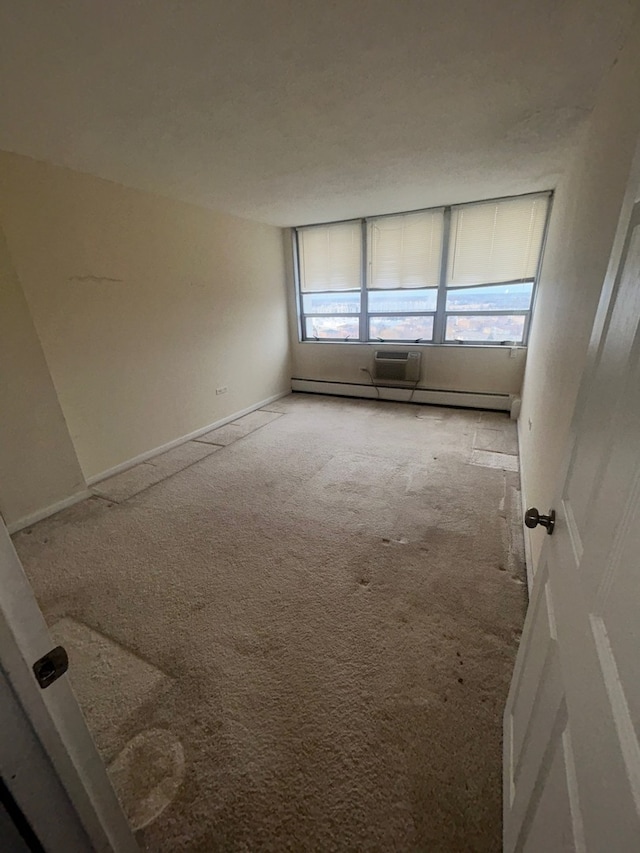 empty room featuring carpet and baseboard heating