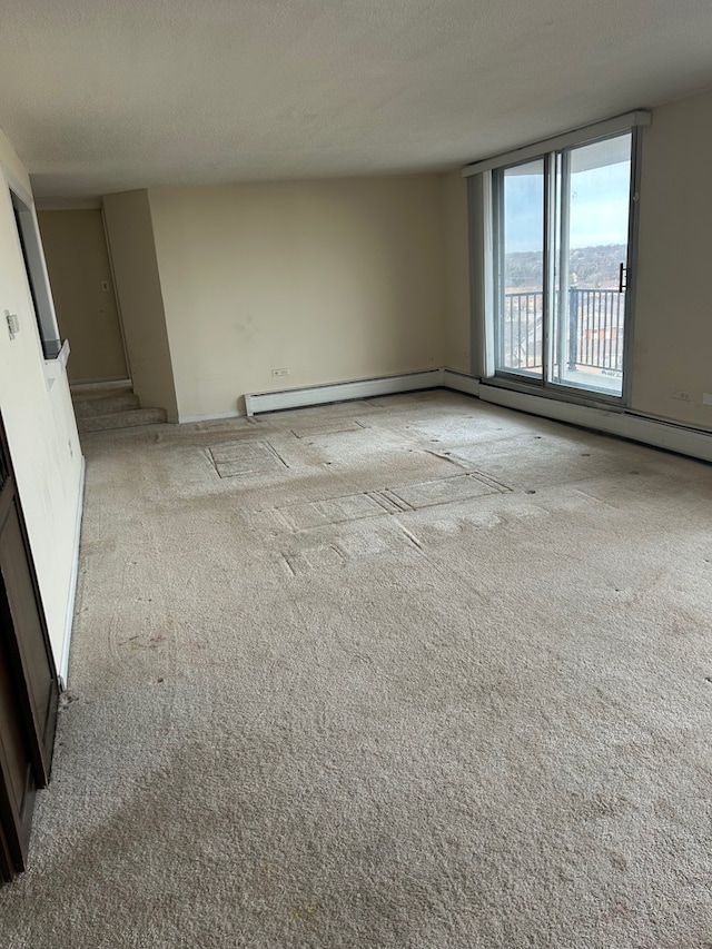 empty room featuring light carpet and a textured ceiling