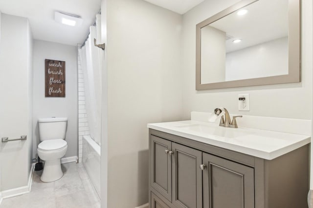 bathroom with shower / bath combo, baseboards, vanity, and toilet