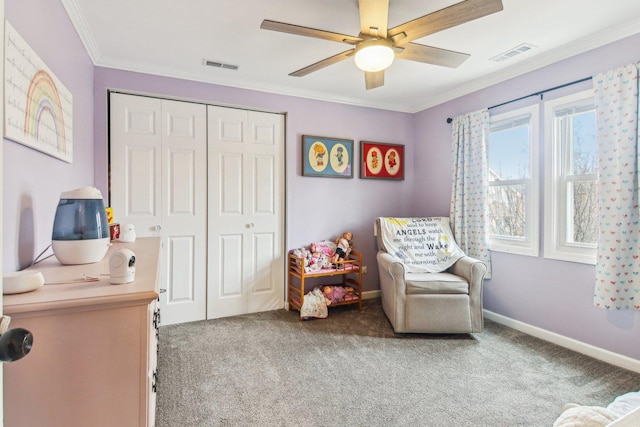 interior space featuring carpet floors, a closet, visible vents, and crown molding