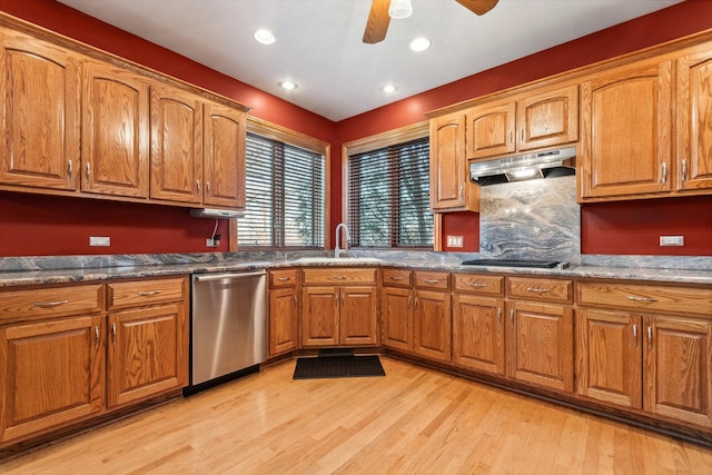 kitchen with under cabinet range hood, a sink, stainless steel dishwasher, light wood finished floors, and brown cabinetry