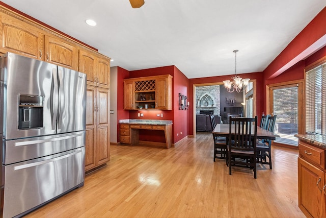 kitchen with open shelves, light wood finished floors, brown cabinetry, and stainless steel refrigerator with ice dispenser