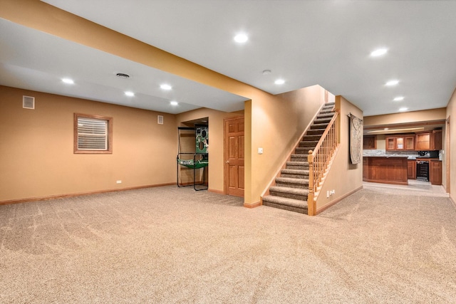 finished below grade area with stairway, light colored carpet, and recessed lighting