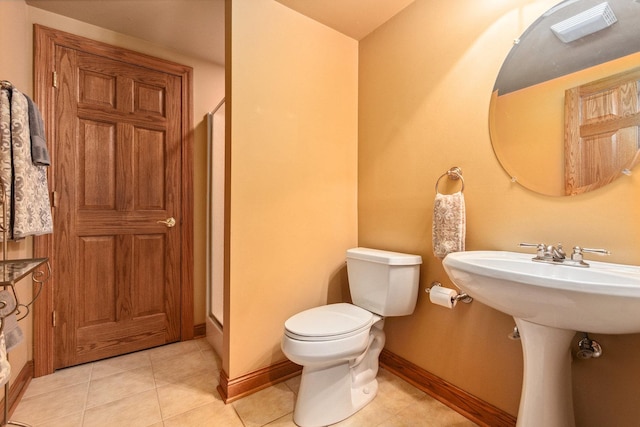 full bathroom with toilet, baseboards, walk in shower, and tile patterned floors