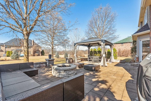 view of patio featuring a gazebo, outdoor dining area, and an outdoor living space with a fire pit