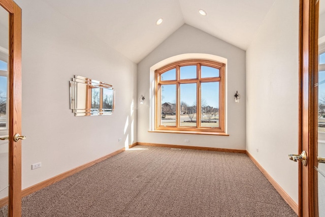 carpeted empty room with vaulted ceiling, french doors, recessed lighting, and baseboards