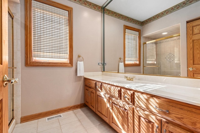 full bathroom featuring a healthy amount of sunlight, visible vents, a shower stall, and vanity