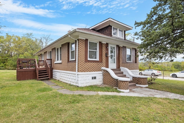 view of front of house with crawl space, brick siding, a deck, and a front lawn