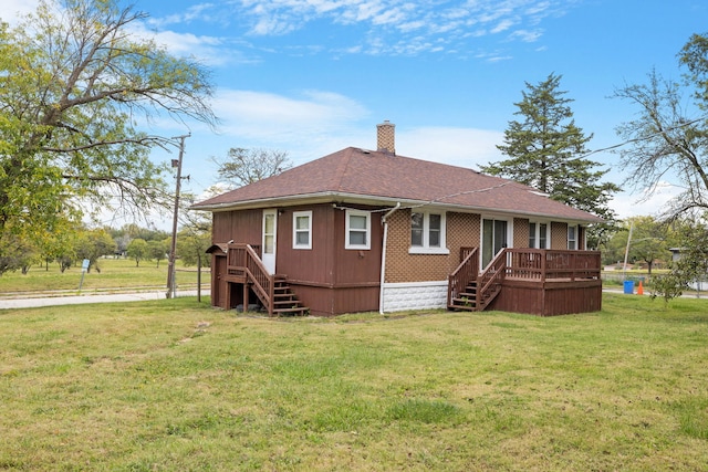 rear view of house with stairs, a chimney, a deck, and a yard