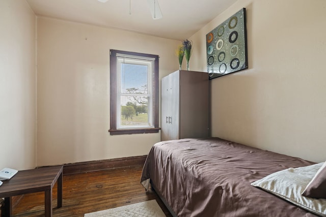 bedroom with dark wood-style floors