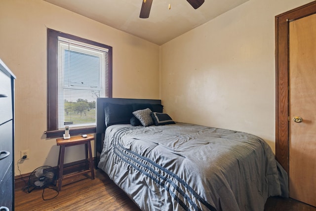 bedroom with a ceiling fan, baseboards, and wood finished floors