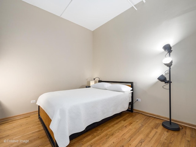 bedroom featuring light wood-style flooring and baseboards