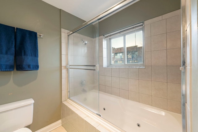 bathroom featuring tiled shower / bath and toilet