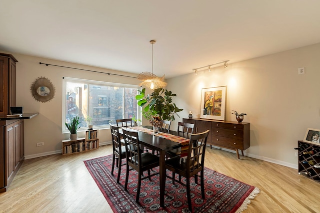 dining room with light wood-style floors and baseboards