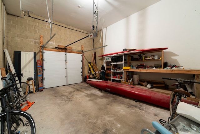 garage featuring a workshop area and concrete block wall