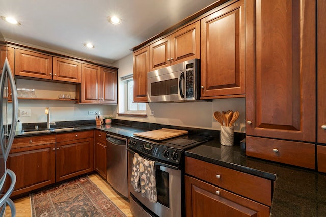 kitchen with open shelves, stainless steel appliances, recessed lighting, brown cabinetry, and a sink