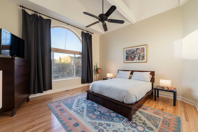 bedroom with a ceiling fan, light wood-type flooring, and baseboards