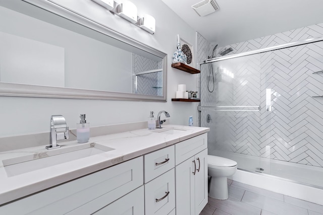 bathroom with toilet, a sink, visible vents, double vanity, and a stall shower