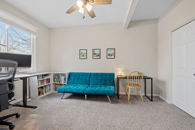 home office with a ceiling fan, baseboards, carpet flooring, and beamed ceiling