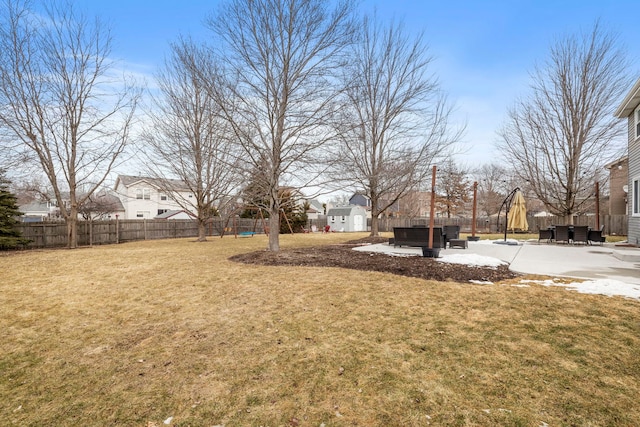 view of yard with a residential view, fence, and a patio