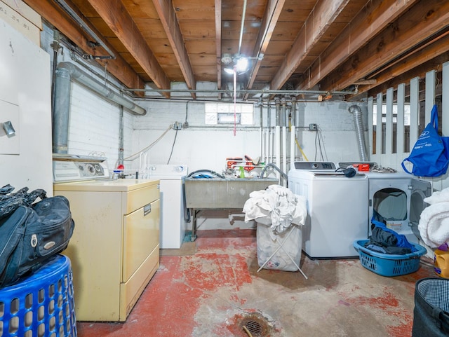 basement with a sink and washer and clothes dryer