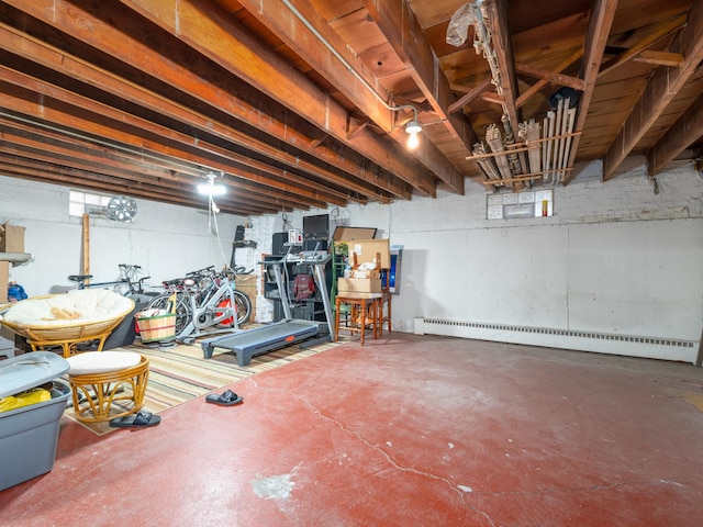 unfinished basement featuring a baseboard radiator