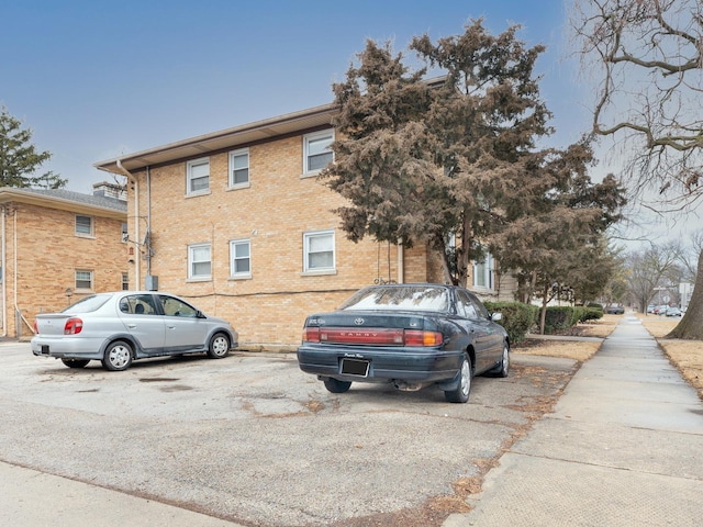 view of property featuring uncovered parking