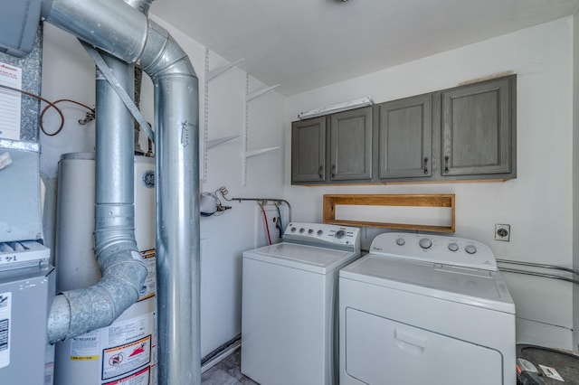 washroom featuring cabinet space and separate washer and dryer