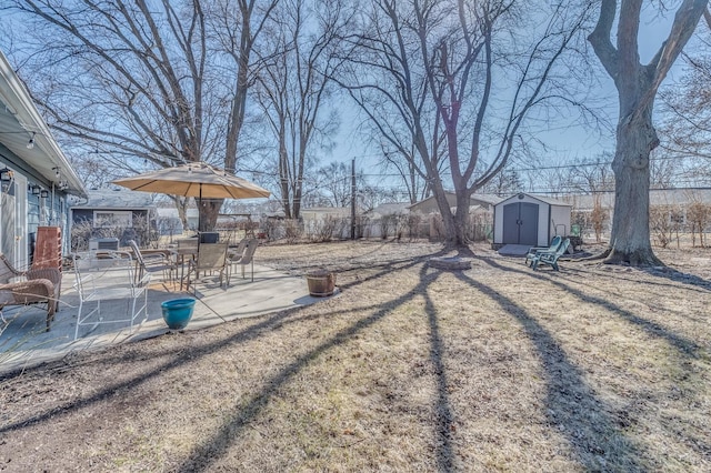 view of yard featuring a patio area, an outbuilding, a fenced backyard, and a shed