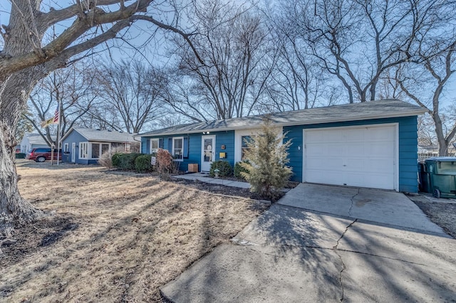 single story home featuring a garage and driveway