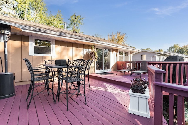 wooden deck with outdoor dining area