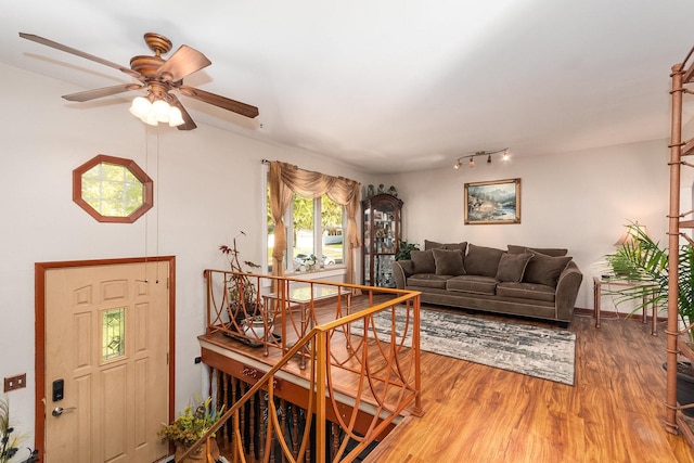 living room with a ceiling fan and wood finished floors