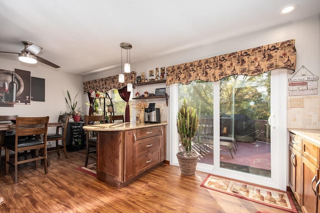 interior space featuring open shelves, pendant lighting, light countertops, and dark wood-type flooring