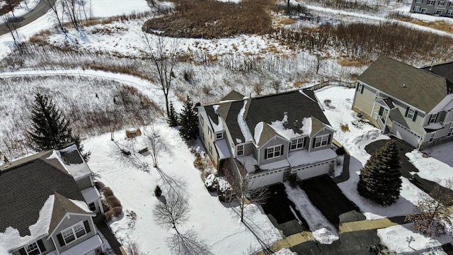 snowy aerial view featuring a residential view