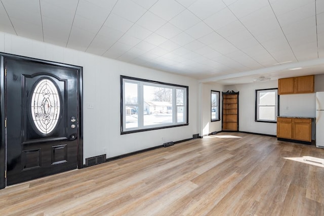 entrance foyer featuring light wood-type flooring, baseboards, and visible vents