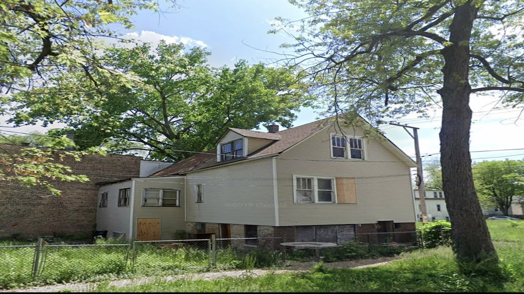 back of property featuring fence