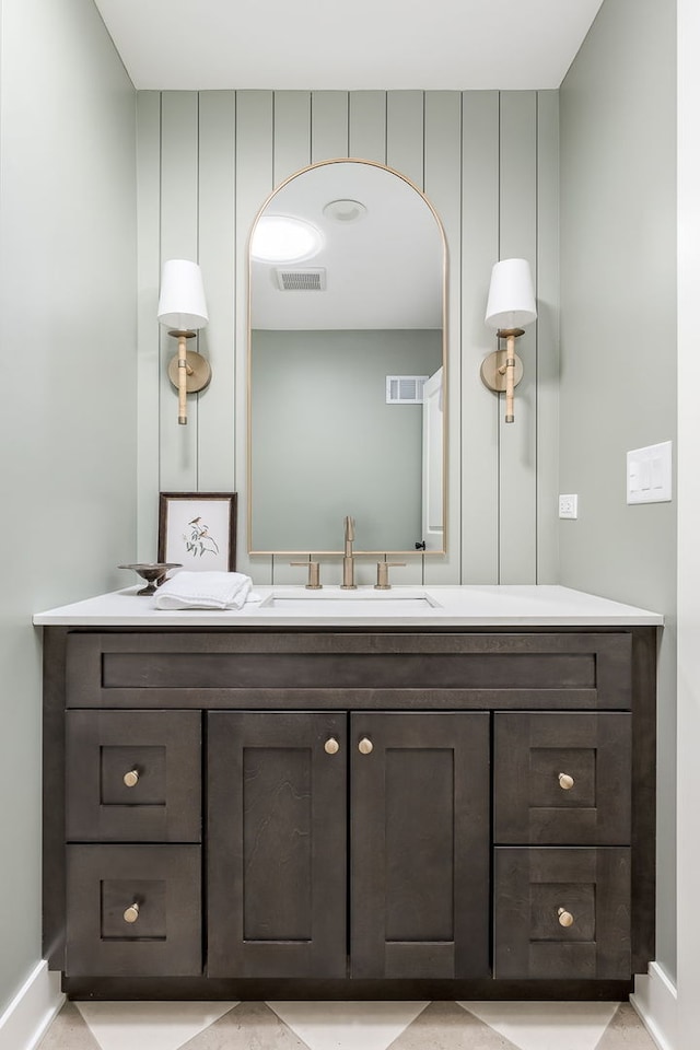 bathroom with baseboards, visible vents, and vanity