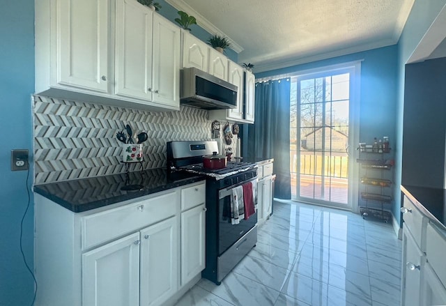 kitchen featuring marble finish floor, stainless steel appliances, tasteful backsplash, ornamental molding, and white cabinets