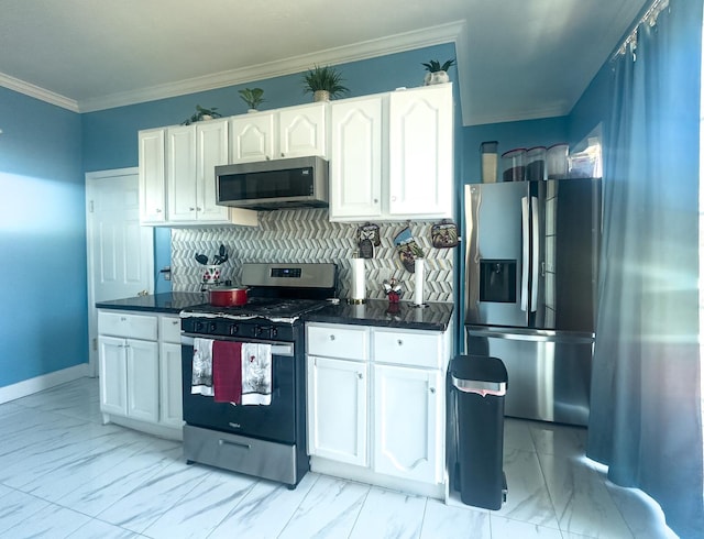 kitchen featuring appliances with stainless steel finishes, dark countertops, marble finish floor, and white cabinets