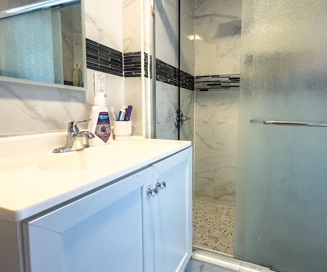 full bath with a shower stall and vanity